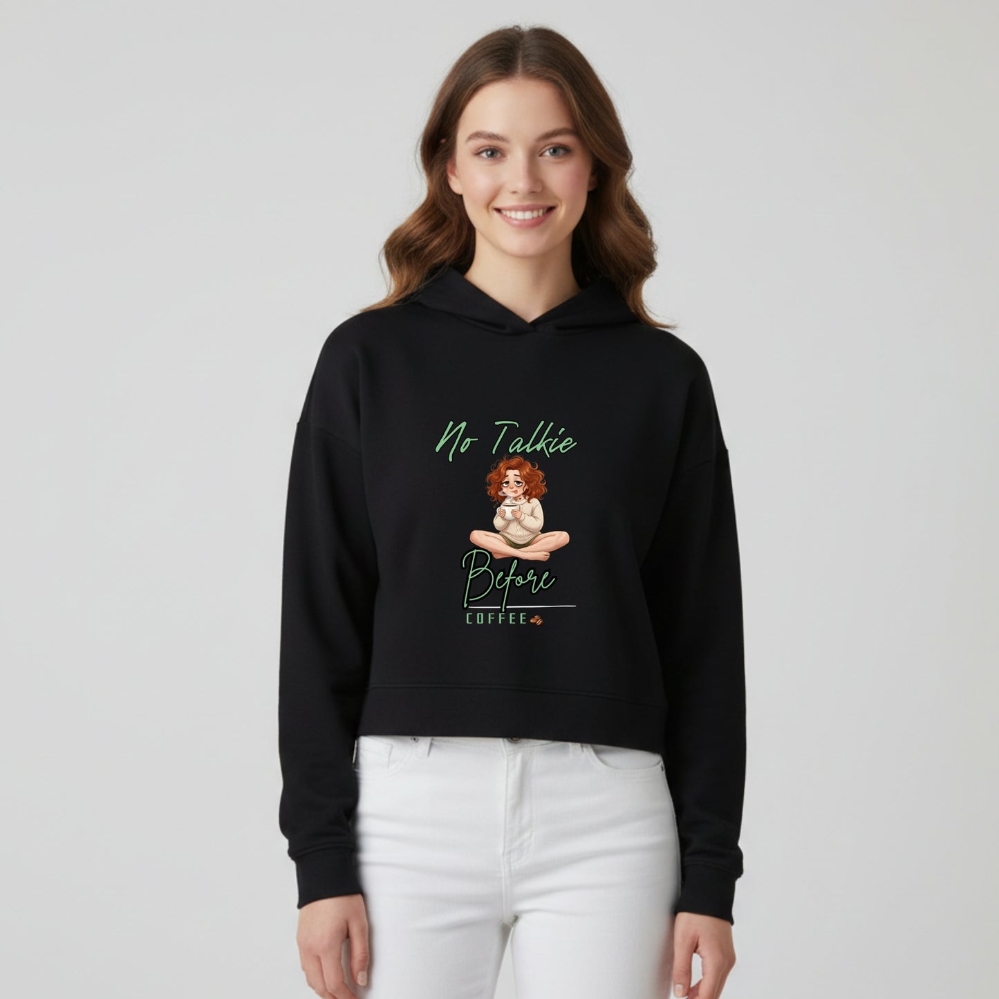 Model wearing women’s cropped hoodie with No Talkie Before Coffee printed design - Artisianaura